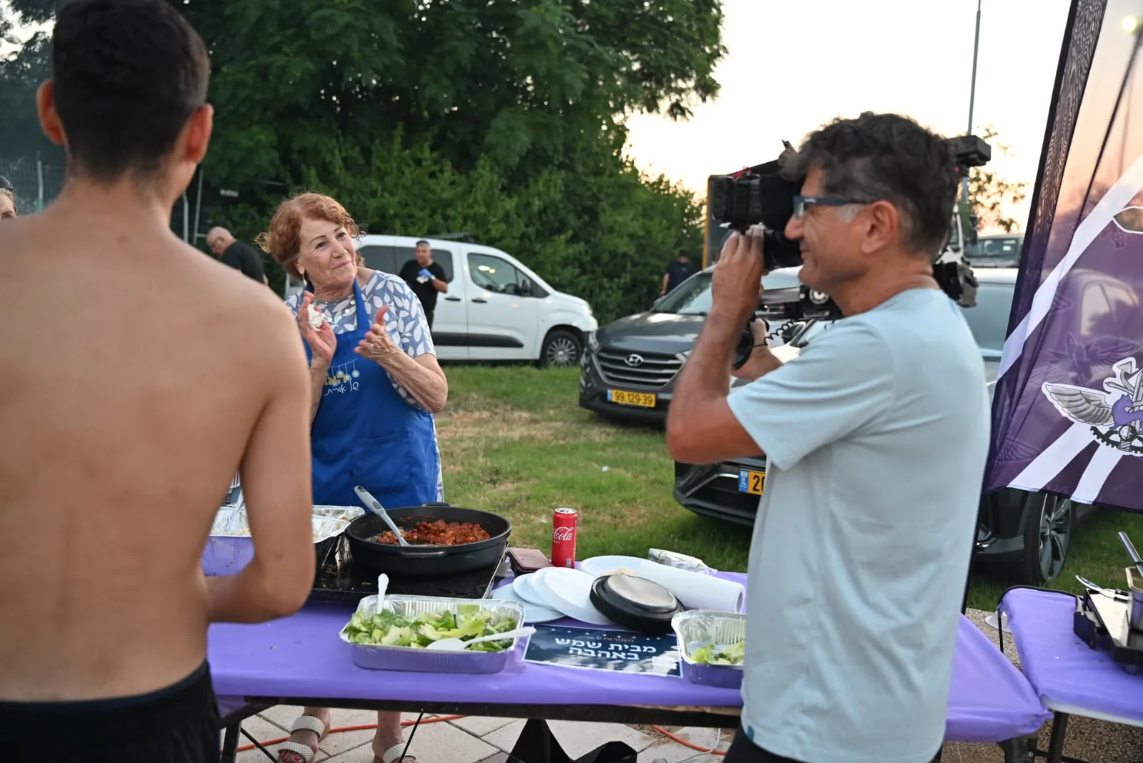 Volunteer serving a home-cooked dish to a soldier