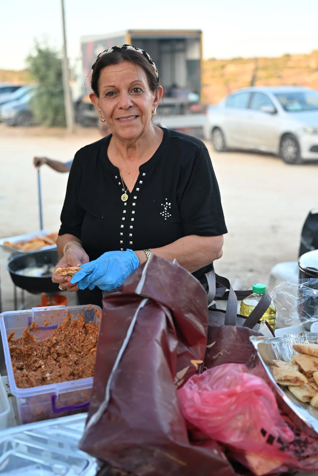 A volunteer filling pastries at the field kitchen