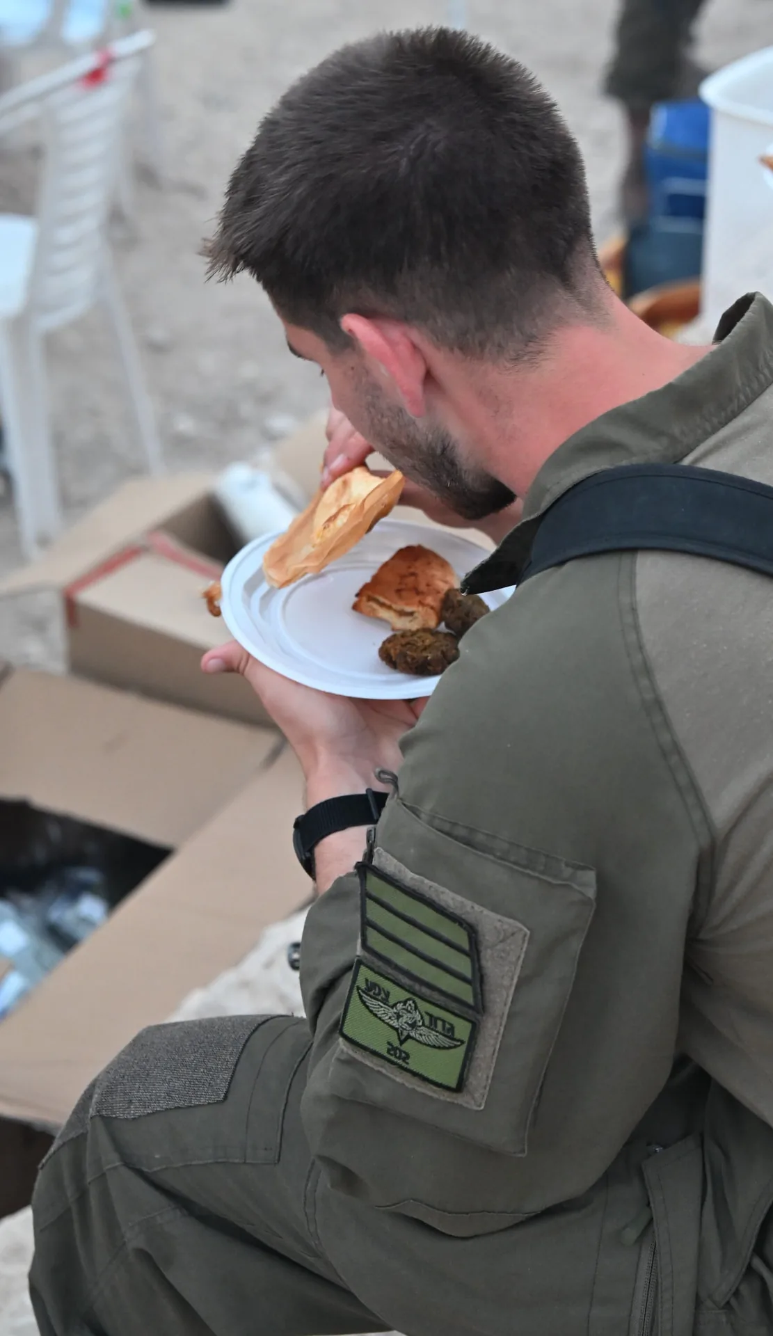 A soldier of the battalion eating a plate of food