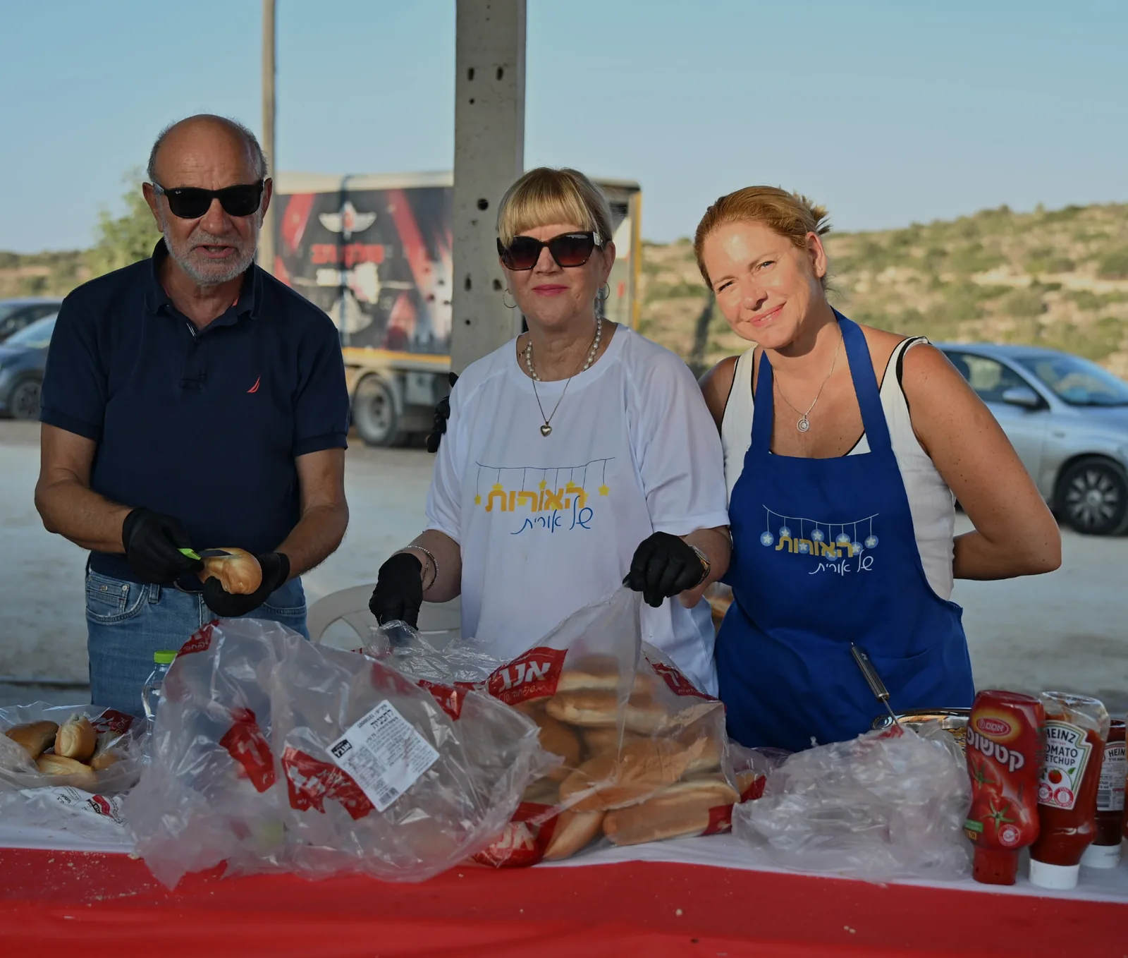 Volunteers preparing bread rolls at the serving table