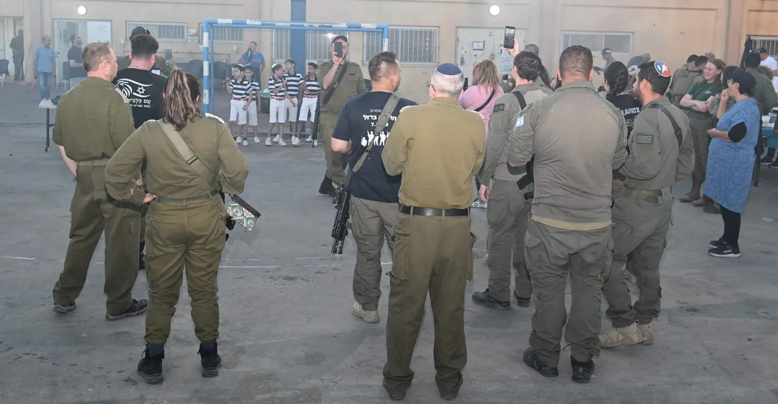 Soldiers gathered to watch a children's choir perform during the evening