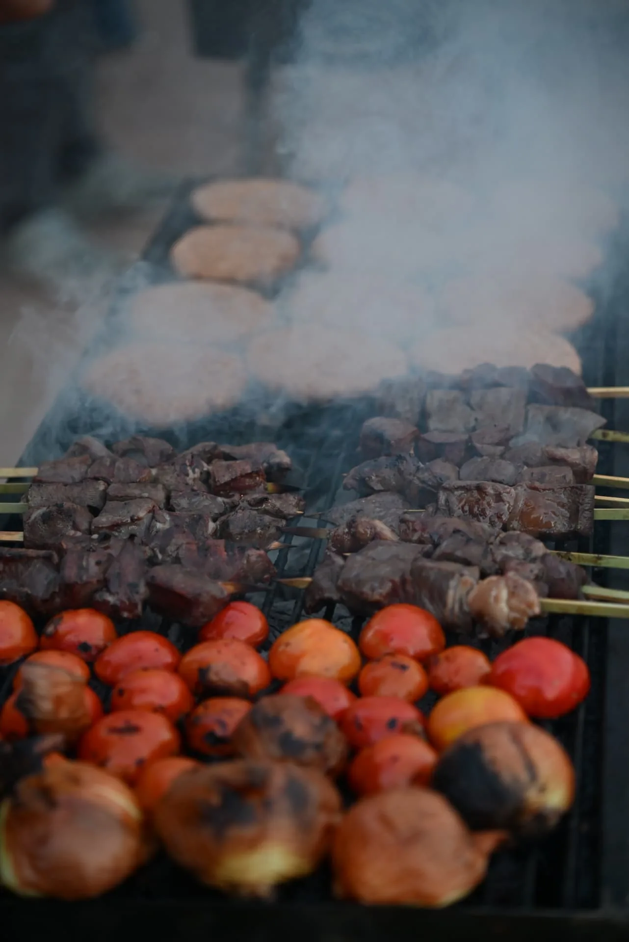 Skewers and vegetables on the grill