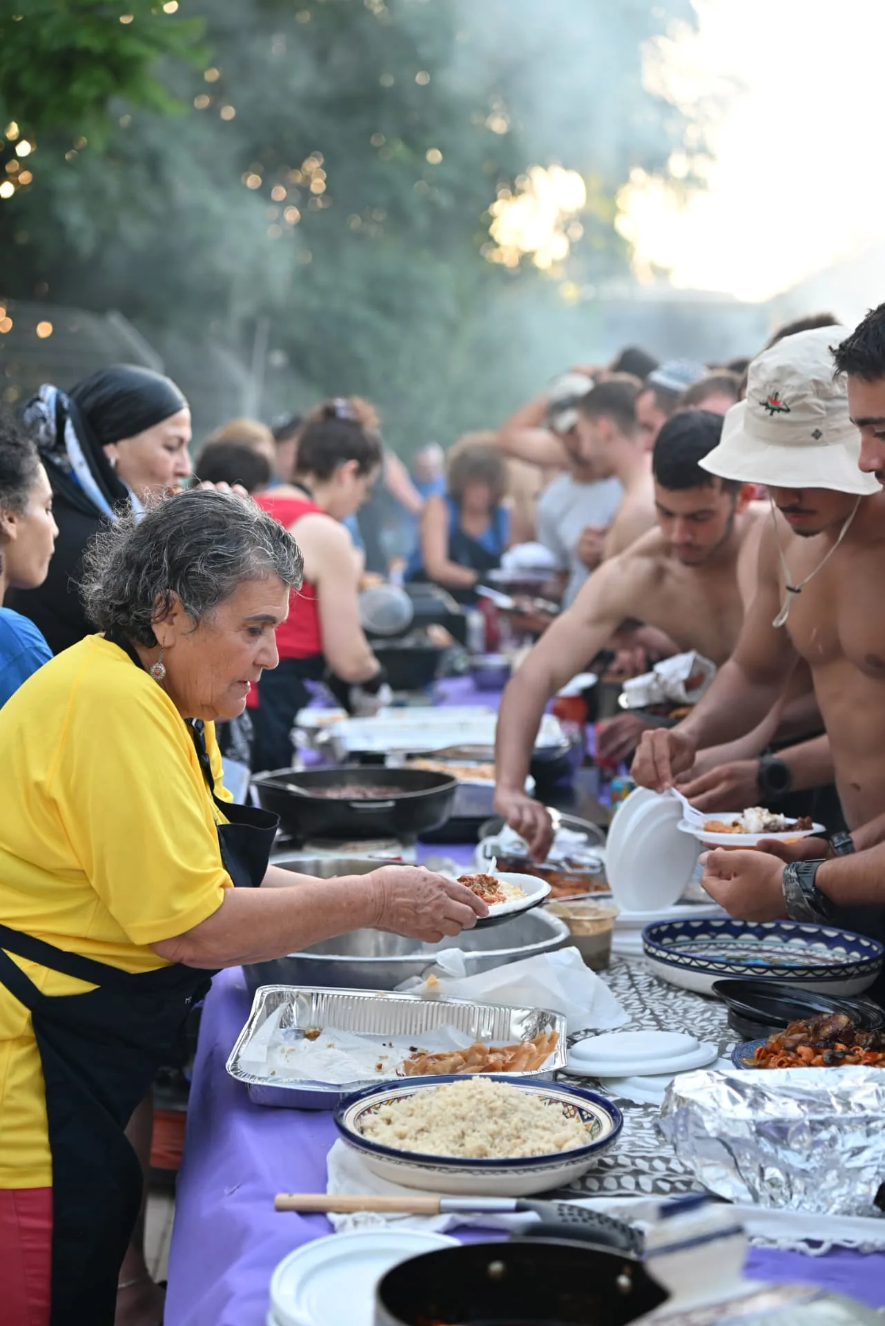 A long serving table with soldiers filling their plates