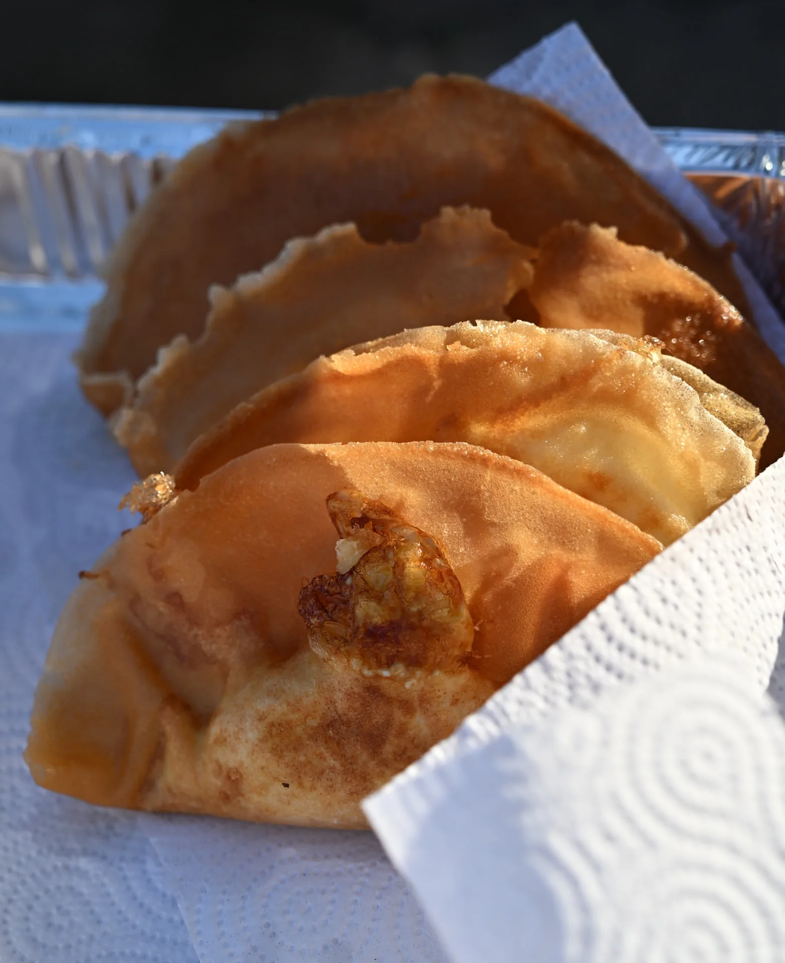 Freshly fried pastries served on a tray