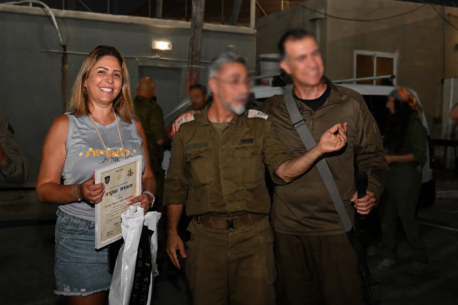A volunteer receives a certificate of appreciation from unit commanders