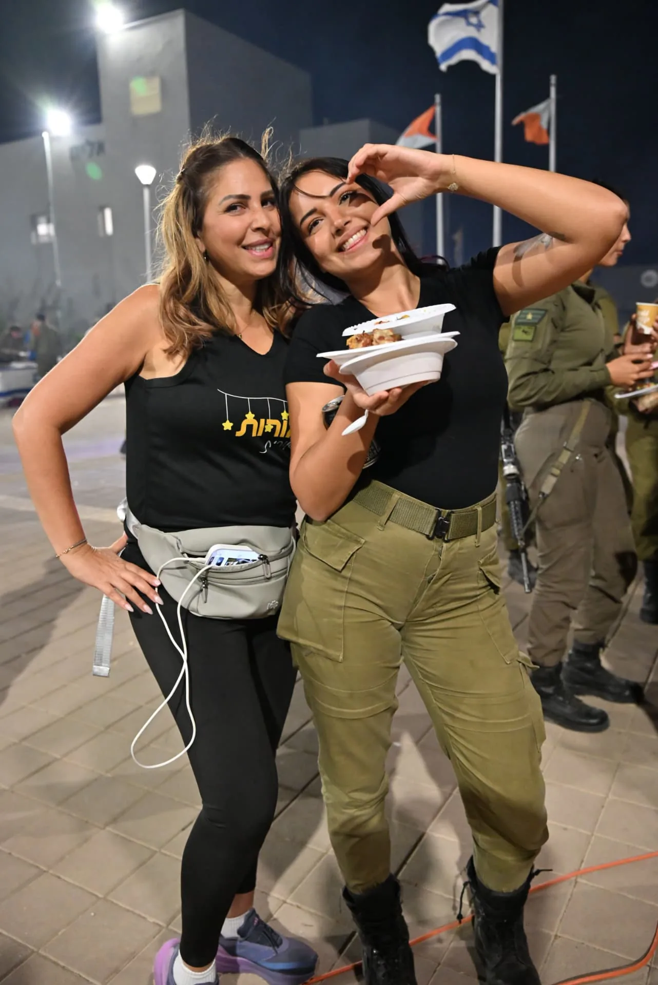 A volunteer and a soldier sharing a happy moment at the appreciation evening