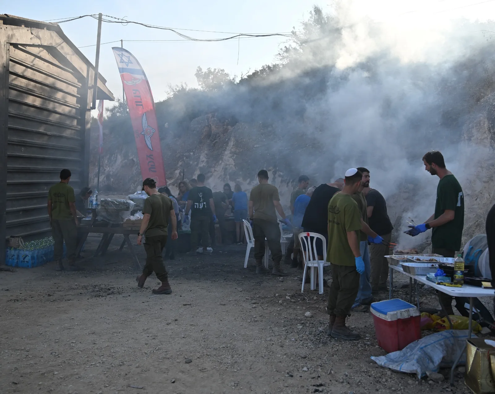 The barbecue area filling with smoke as the meal is prepared