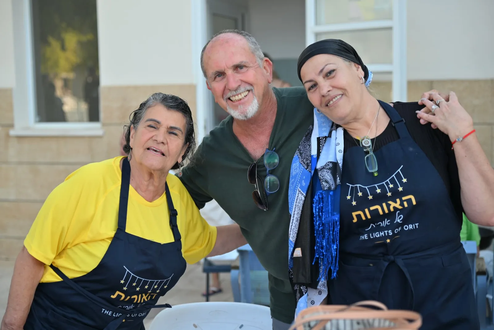Volunteers laughing together in branded aprons