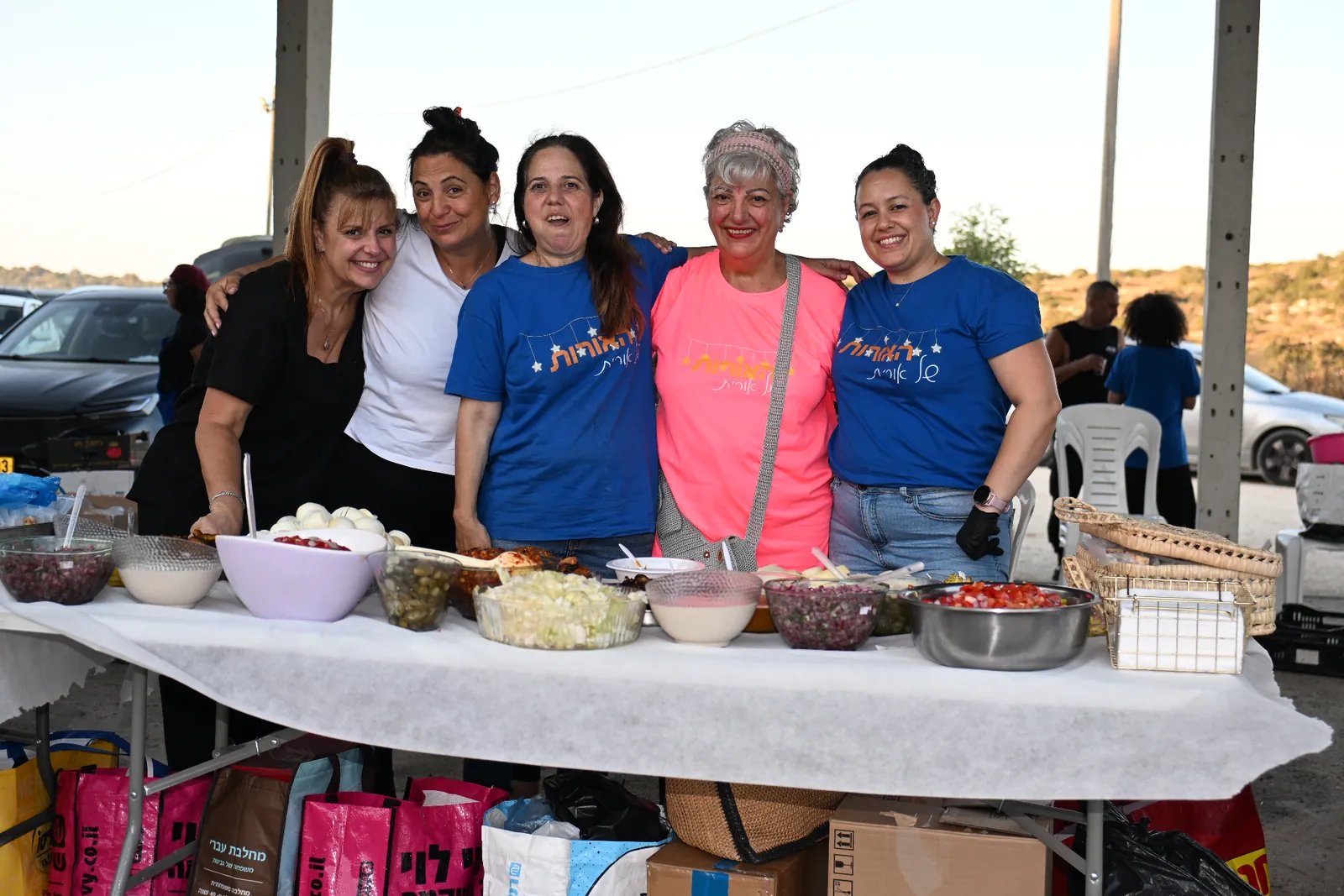 Volunteers standing together behind the prepared meal table