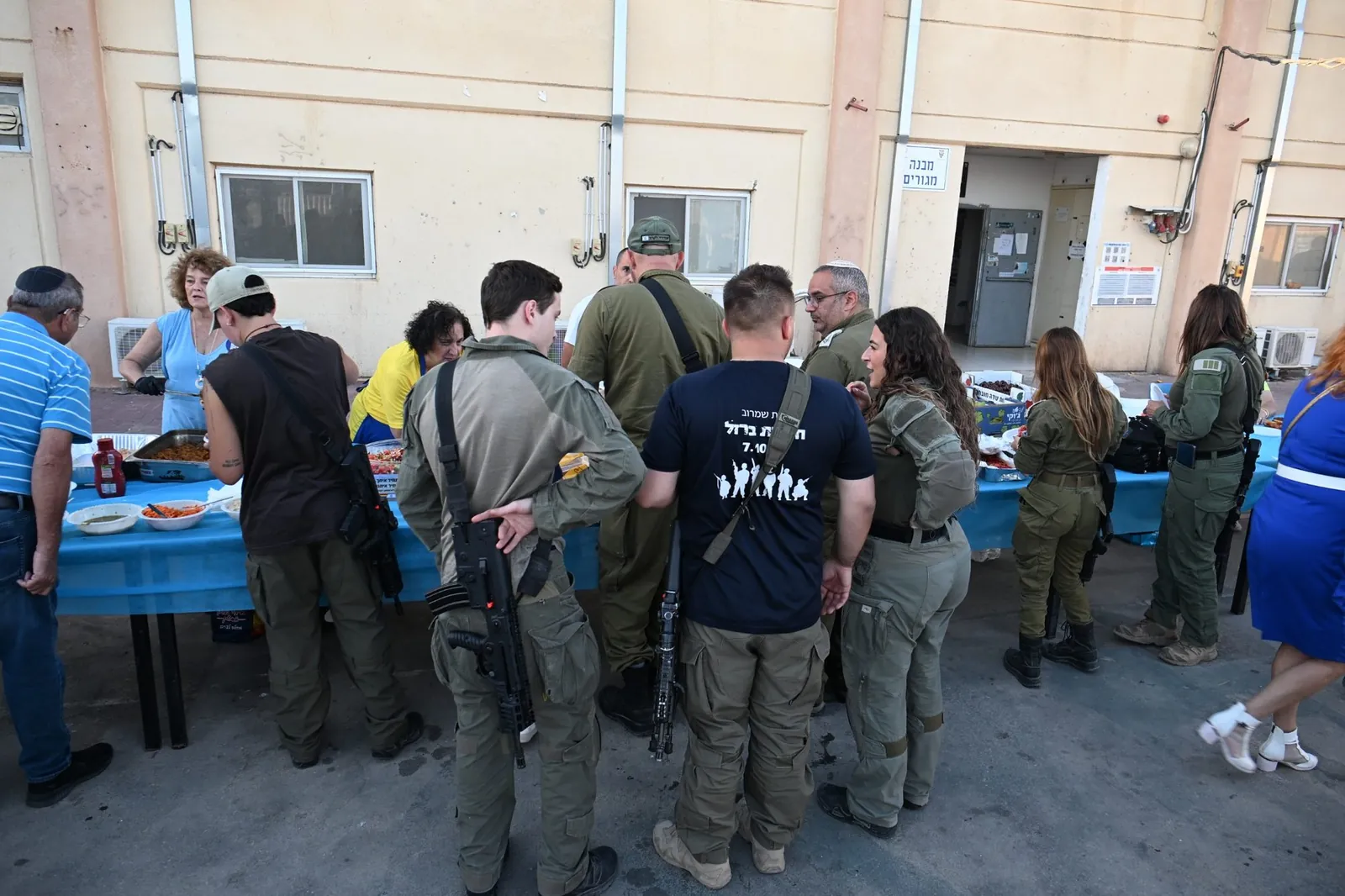 Volunteers serving a warm meal to soldiers at the 7663 Battalion evening