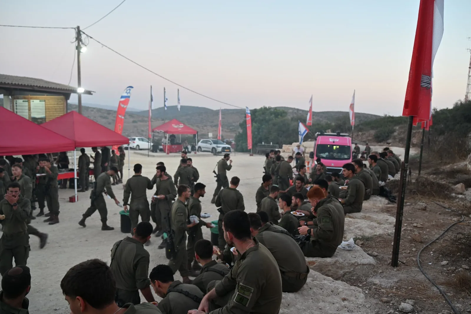 Soldiers eating together across the base courtyard