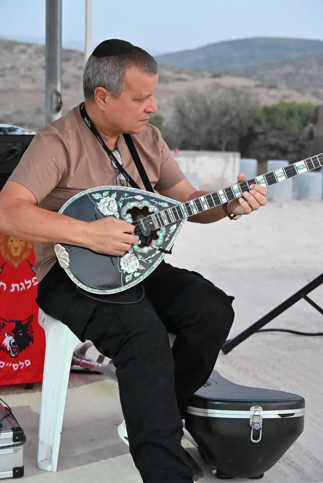 A musician playing bouzouki at the appreciation evening