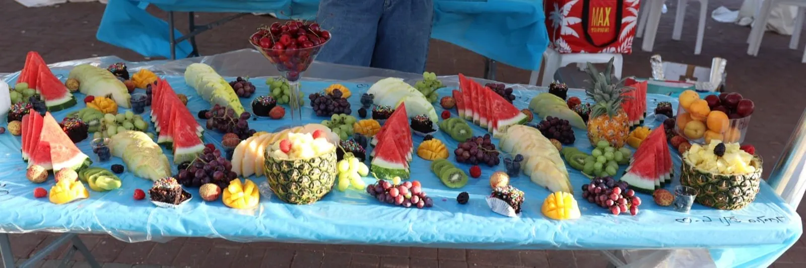 A long table of beautifully arranged fresh fruit for the appreciation evening