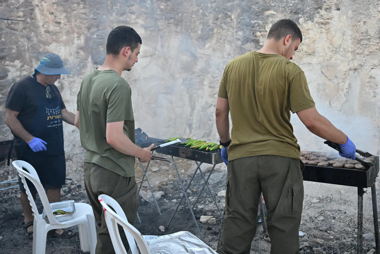 Soldiers and volunteers grilling together