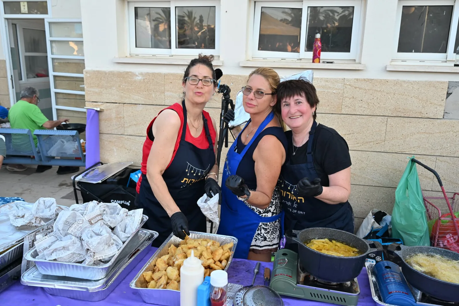 Volunteers frying and serving hot food