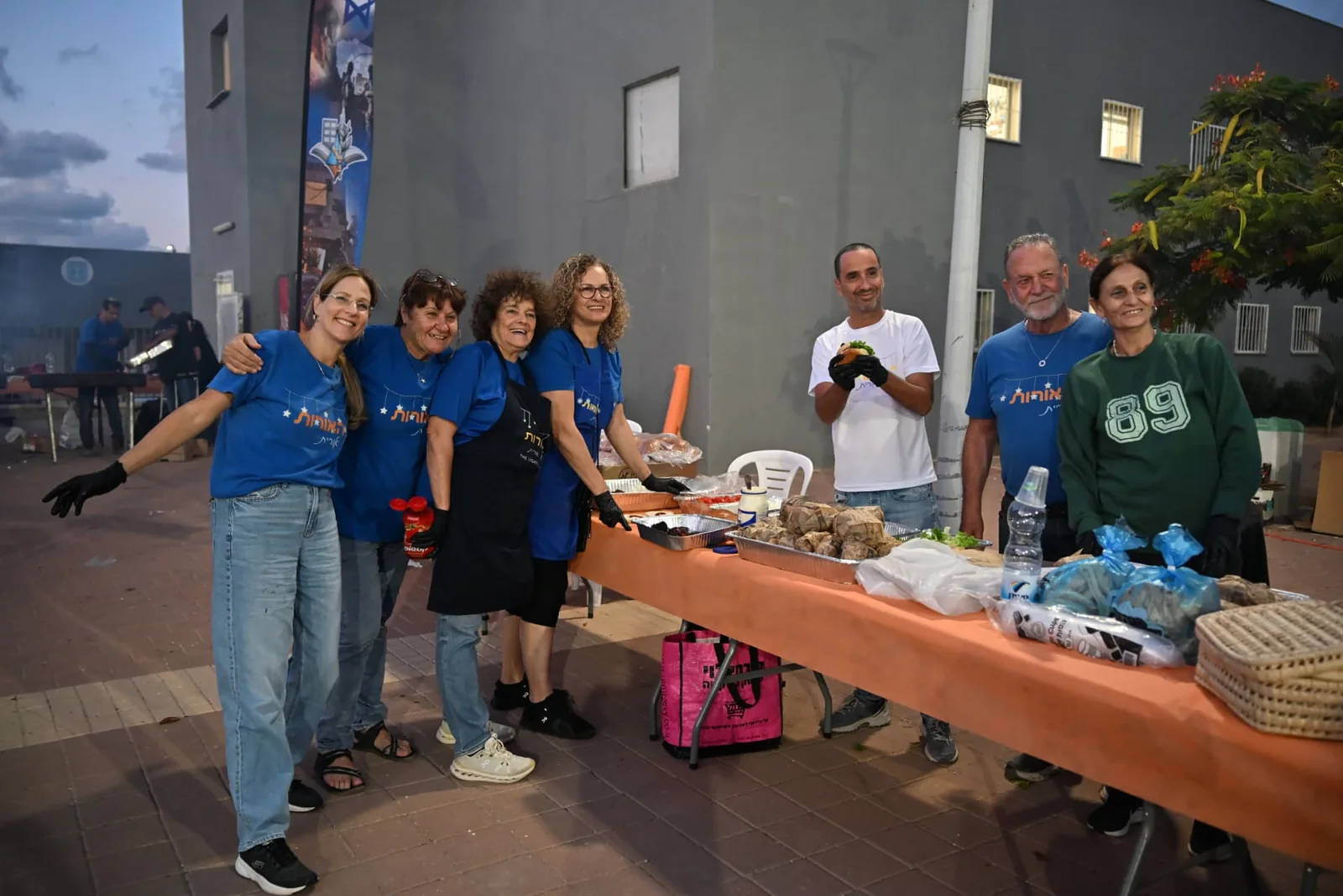 Volunteers beside the buffet table