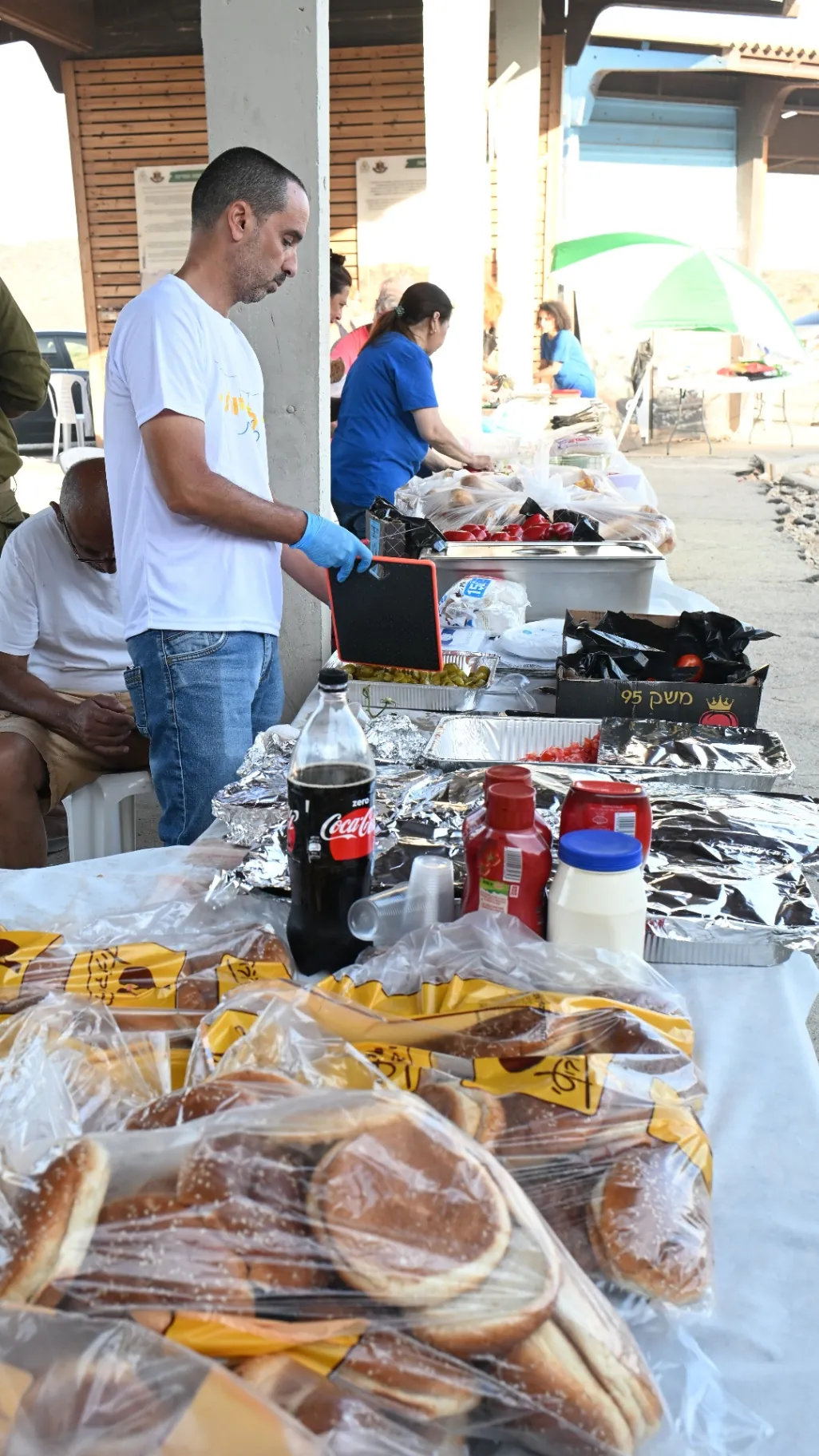 Volunteer setting up the spread of fresh bread and food