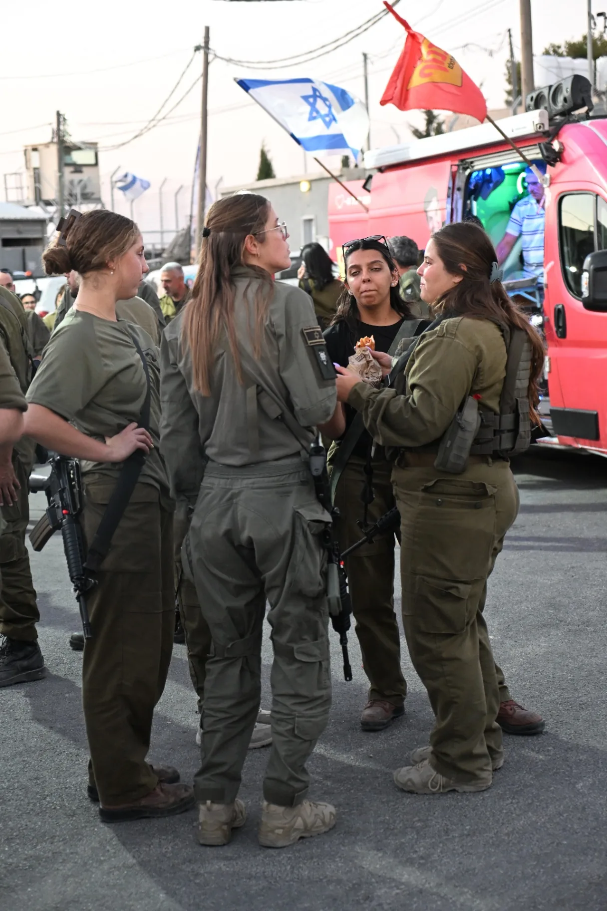 Soldiers talking together with fresh food in hand beside the food truck