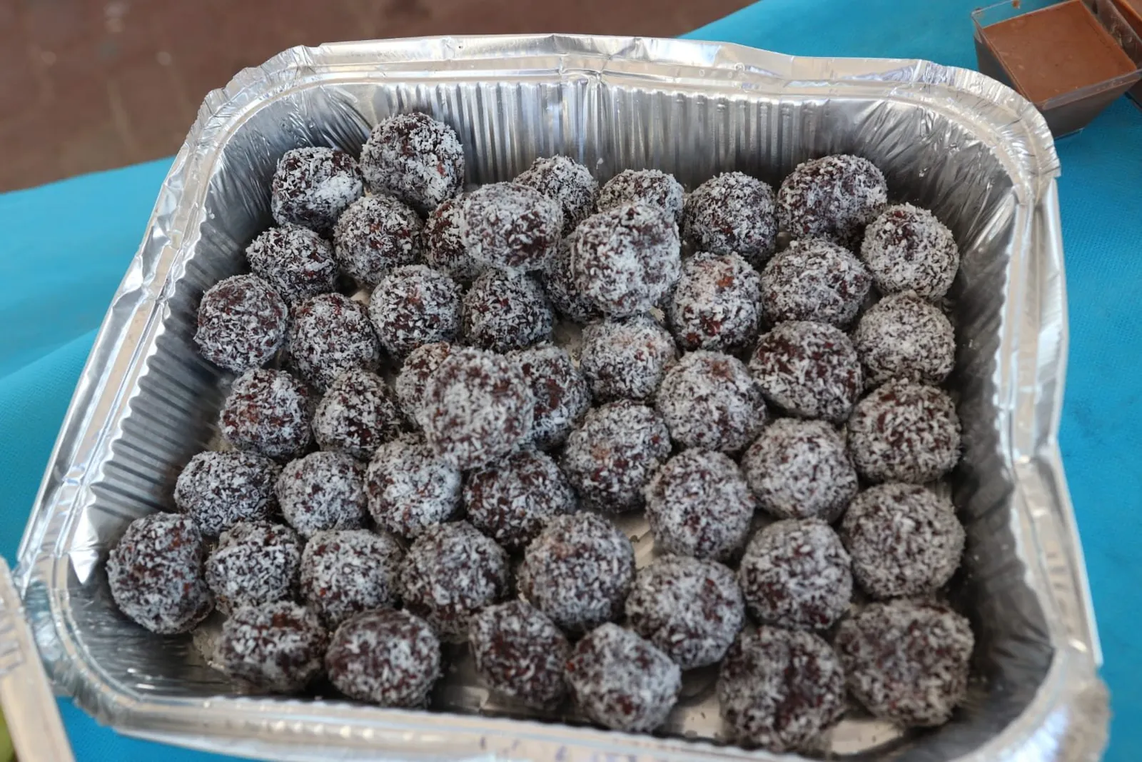 A tray of homemade chocolate coconut balls prepared for the evening
