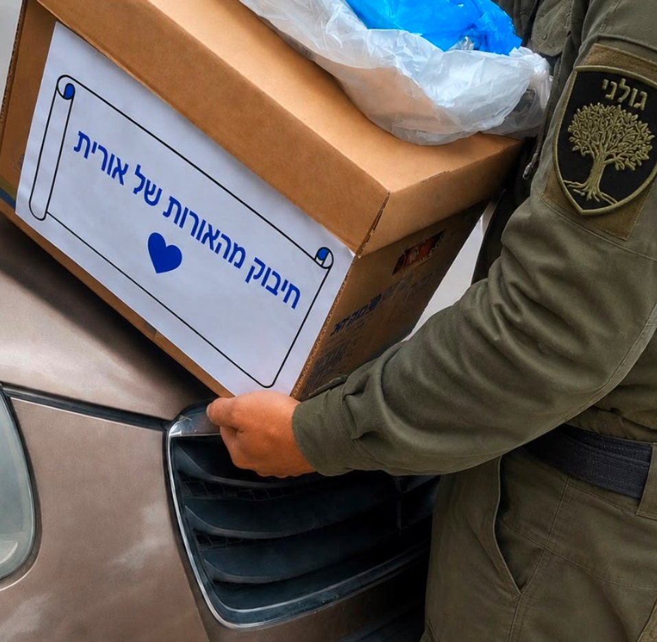 A Golani soldier receiving a care package from The Lights of Orit