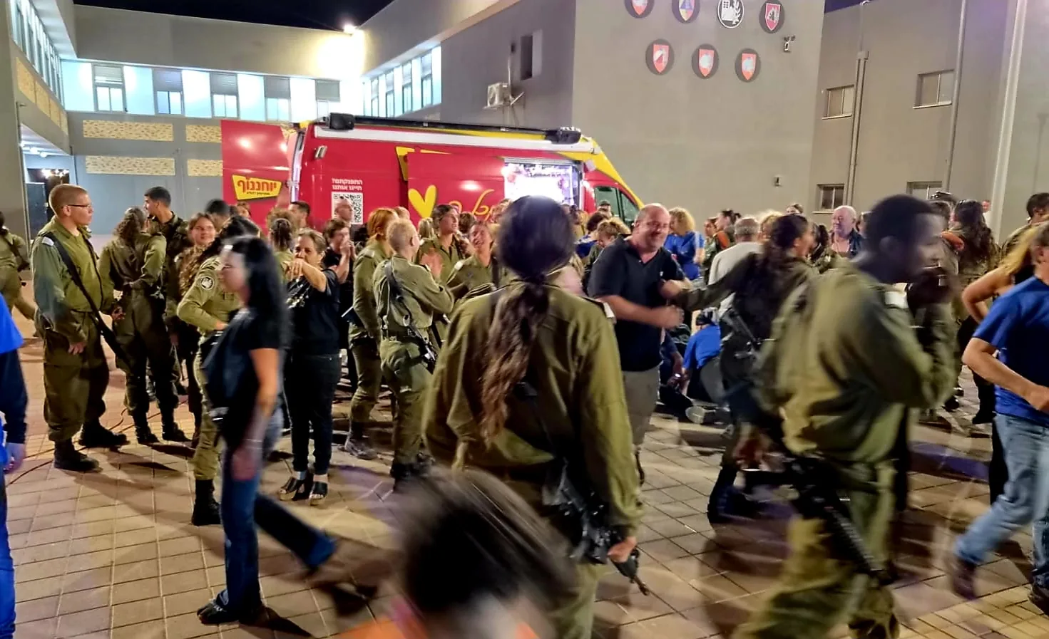 Soldiers and volunteers celebrating together in the evening