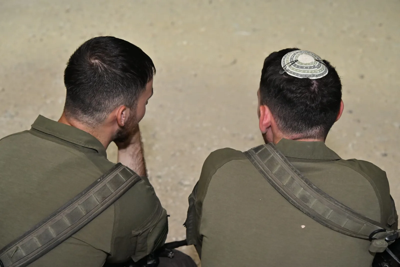 Two soldiers sitting together in quiet conversation