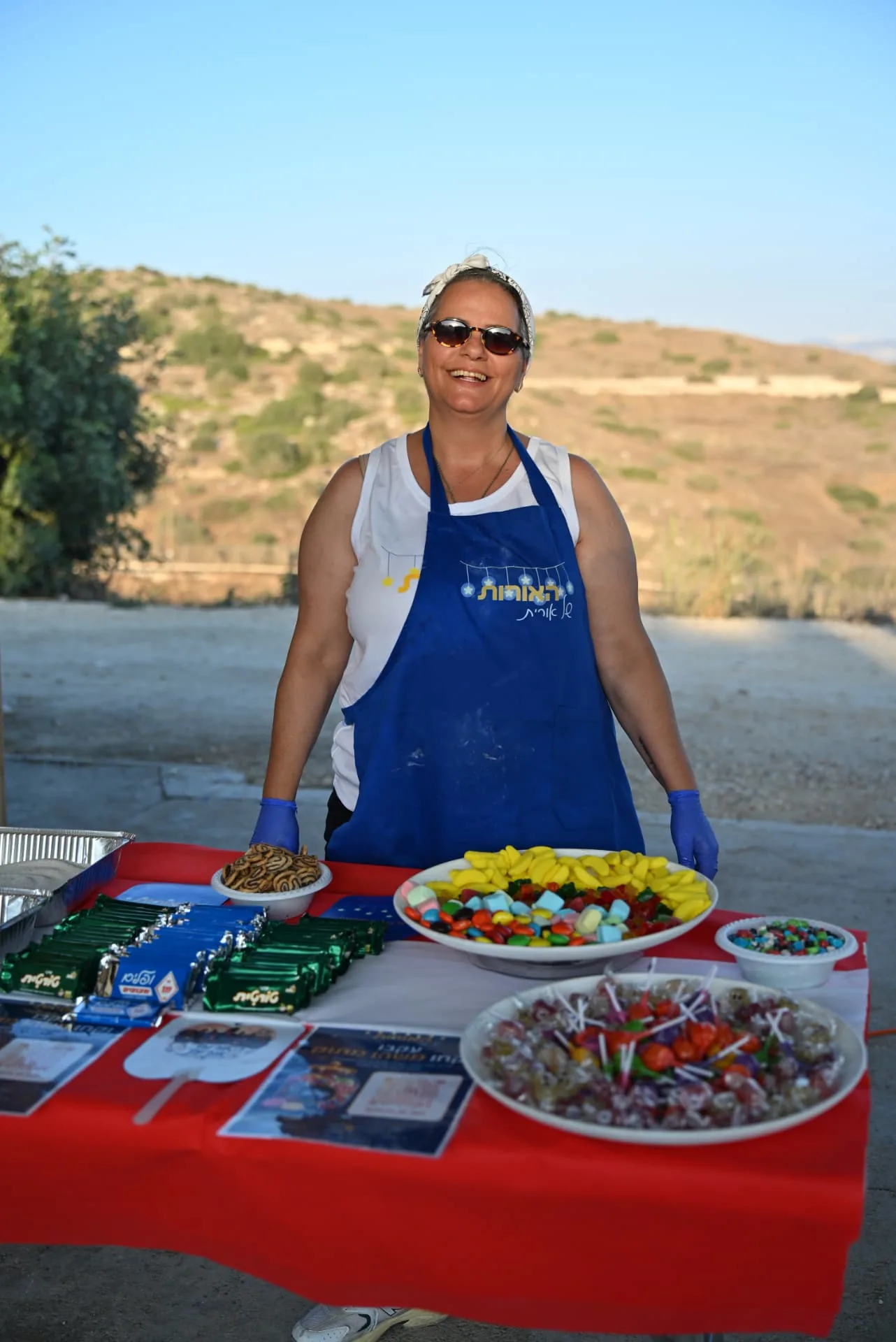 A Lights of Orit volunteer at the sweets and candy table