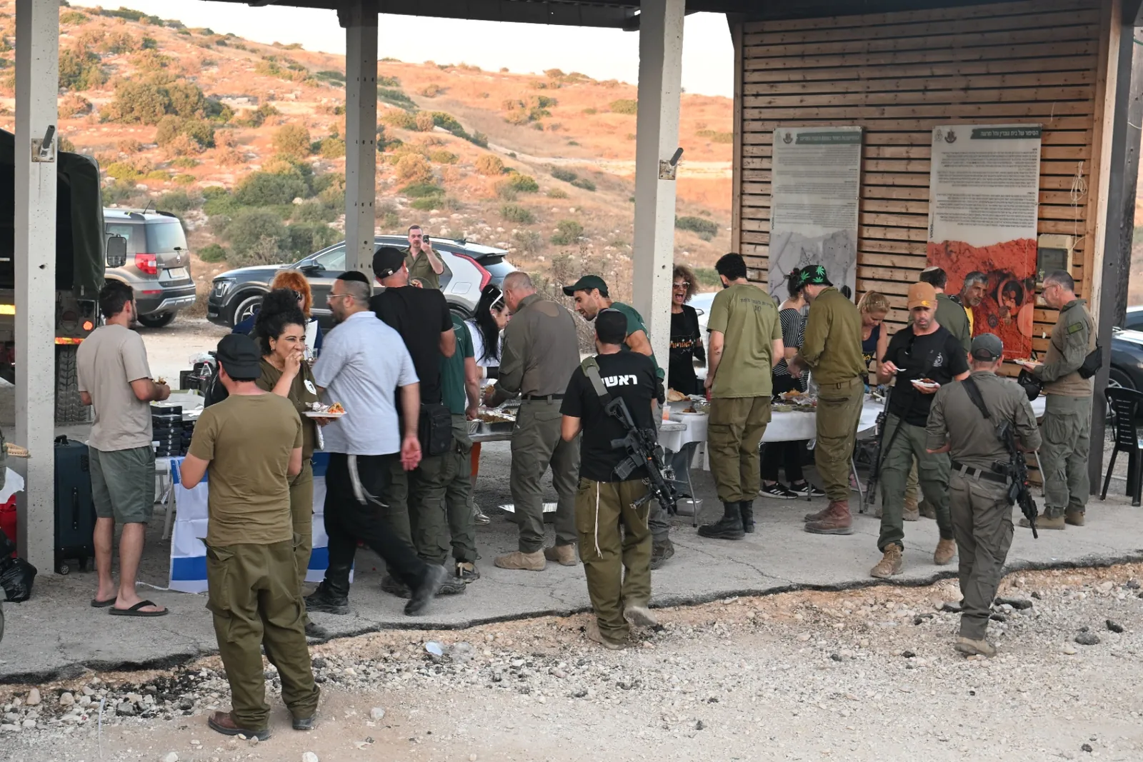 Soldiers and volunteers gathered around the food tables