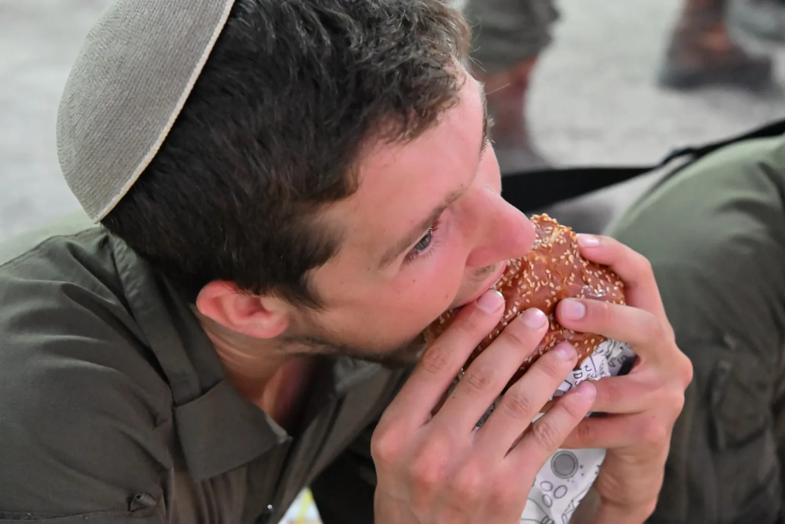 A soldier enjoying a fresh burger