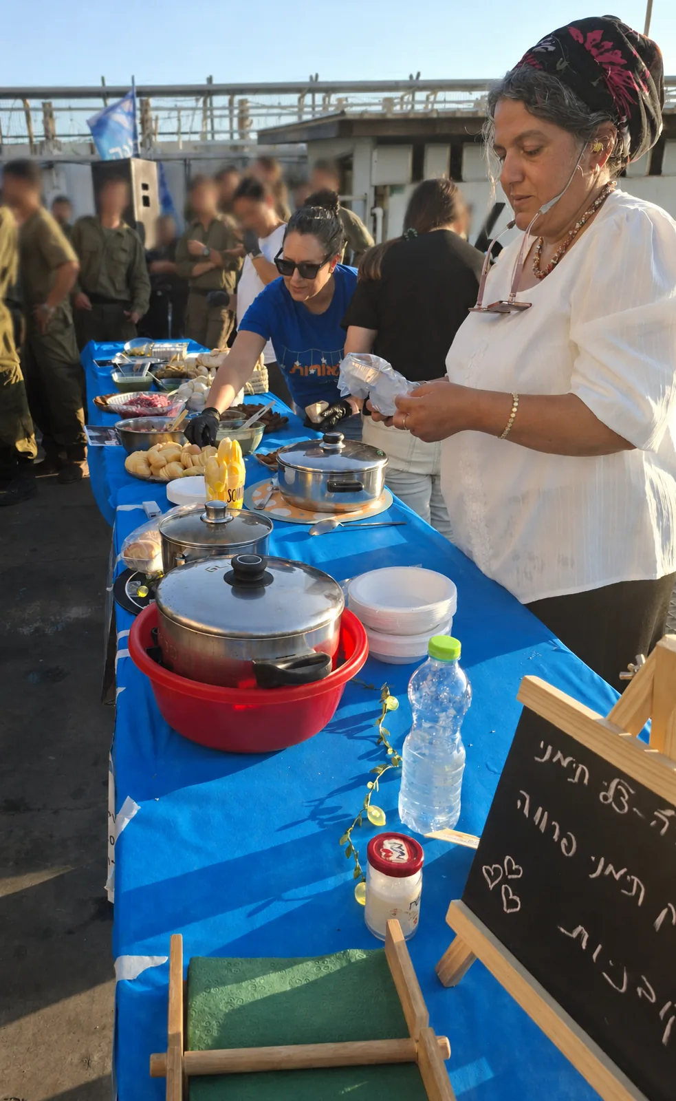 Volunteers serving a warm buffet of homemade food to soldiers at an evening of appreciation