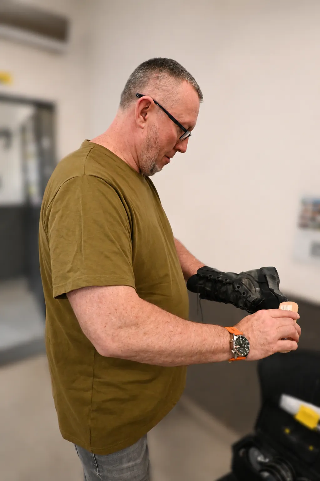 Volunteer polishes boots