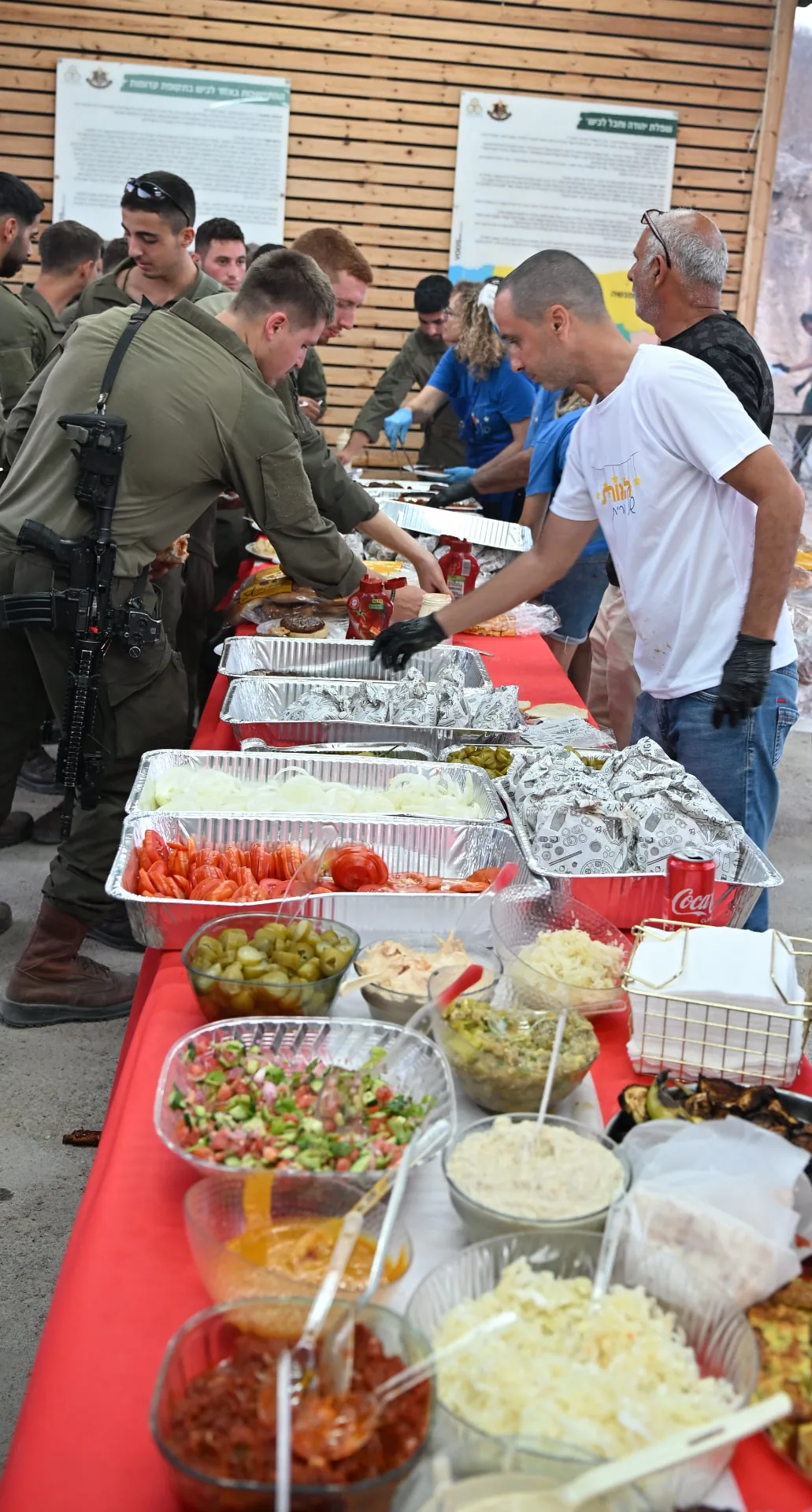 Soldiers filling their plates along the buffet table