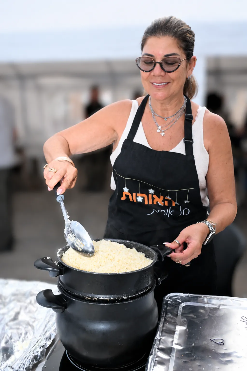 A volunteer serves up fresh couscous