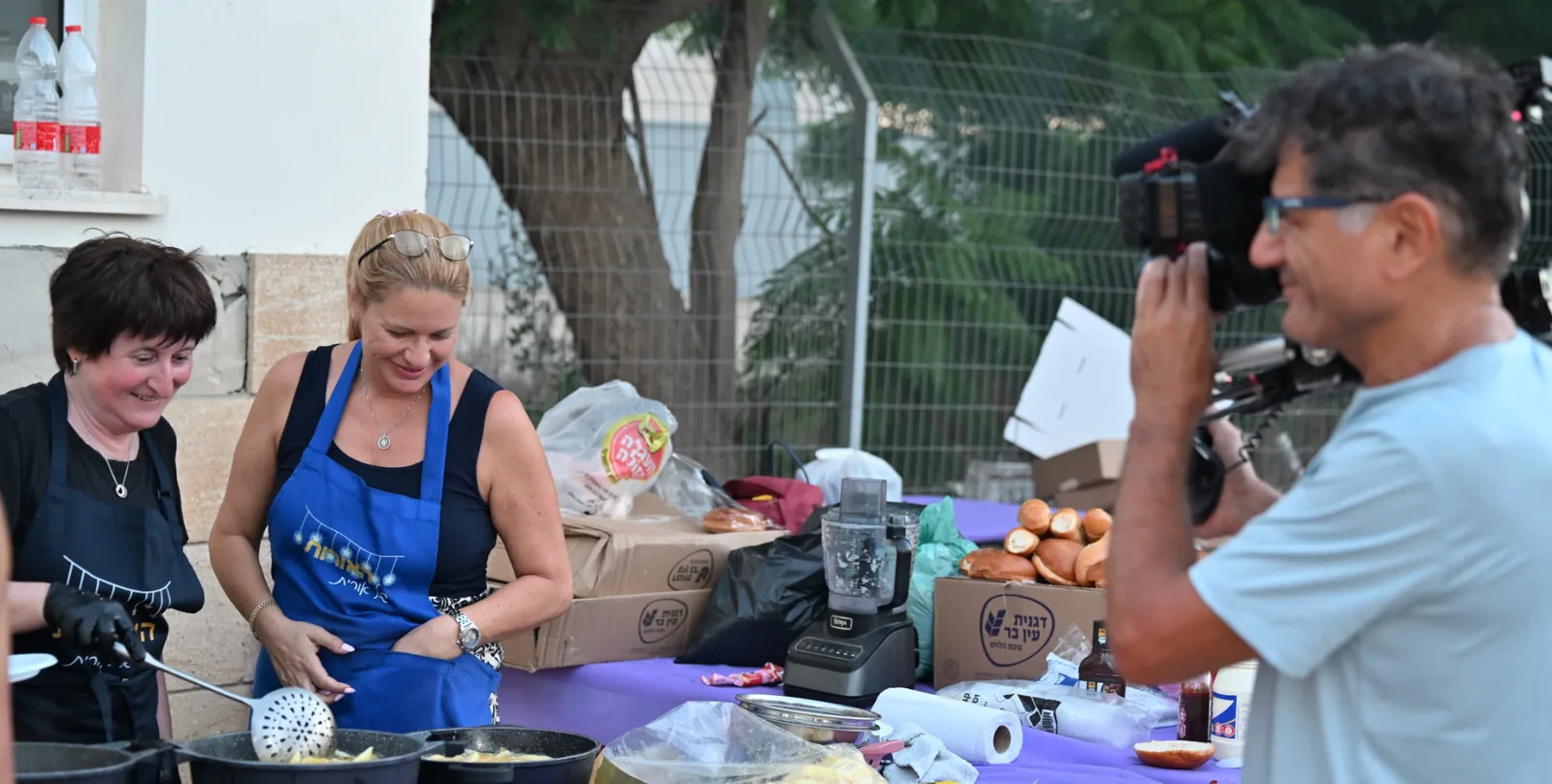 Volunteers frying and preparing food together