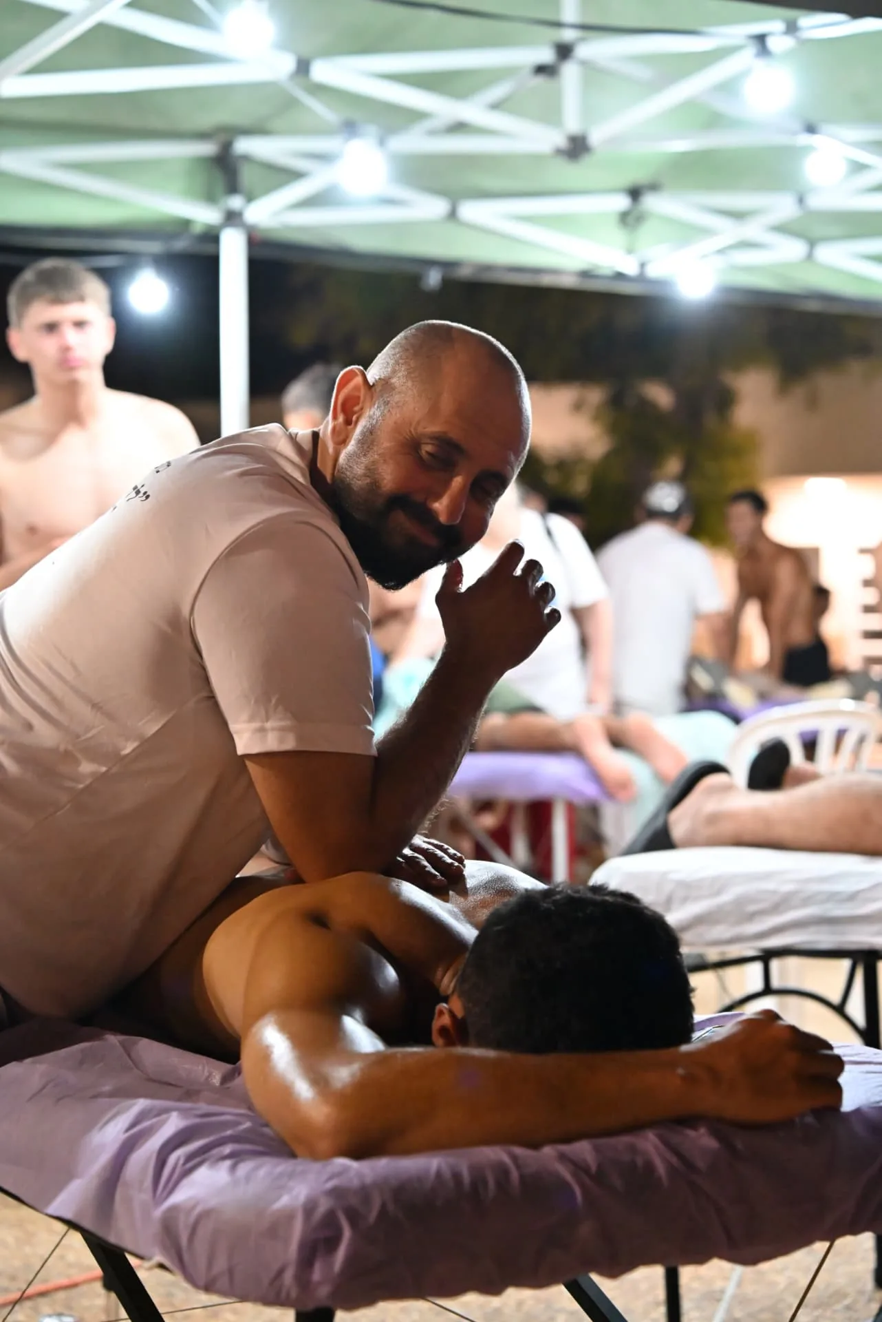 Therapist working under the lights of the treatment tent