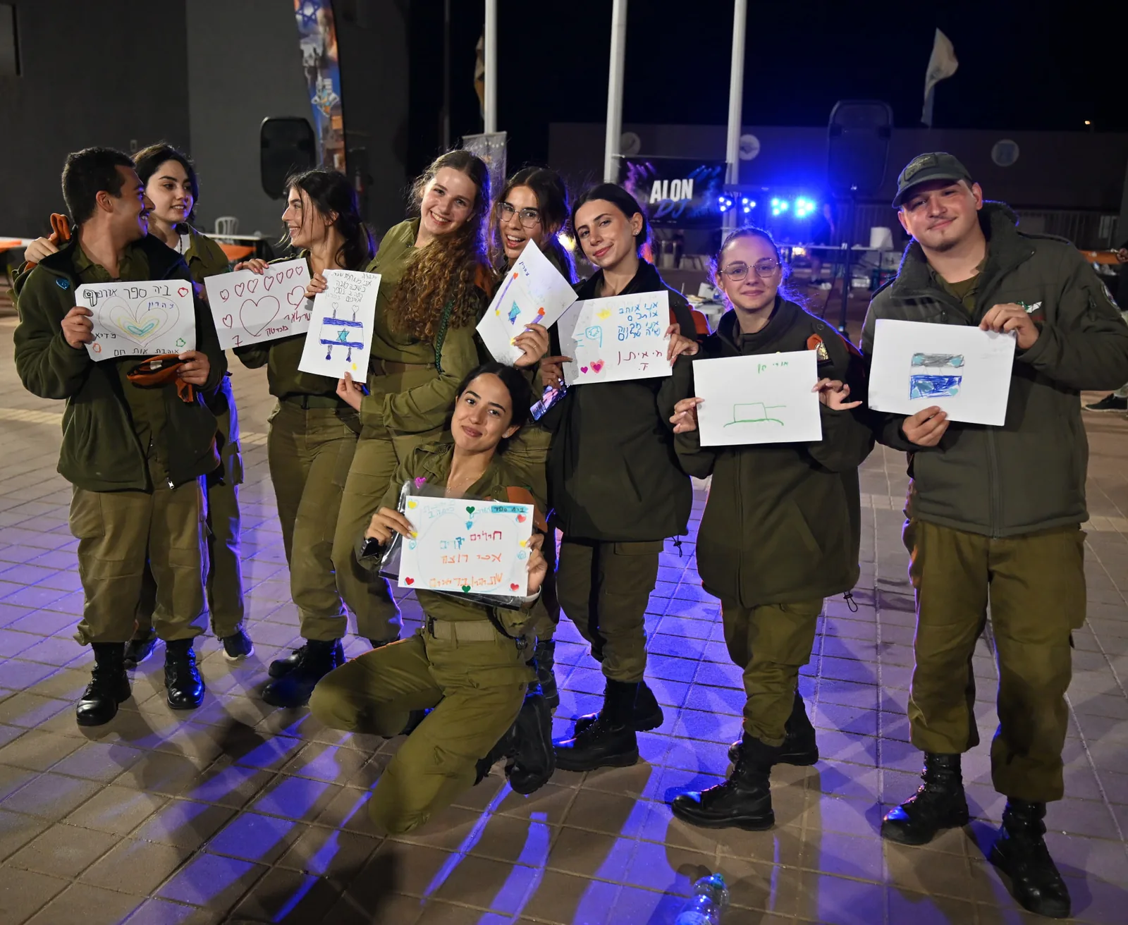 Soldiers displaying their artwork at the appreciation evening