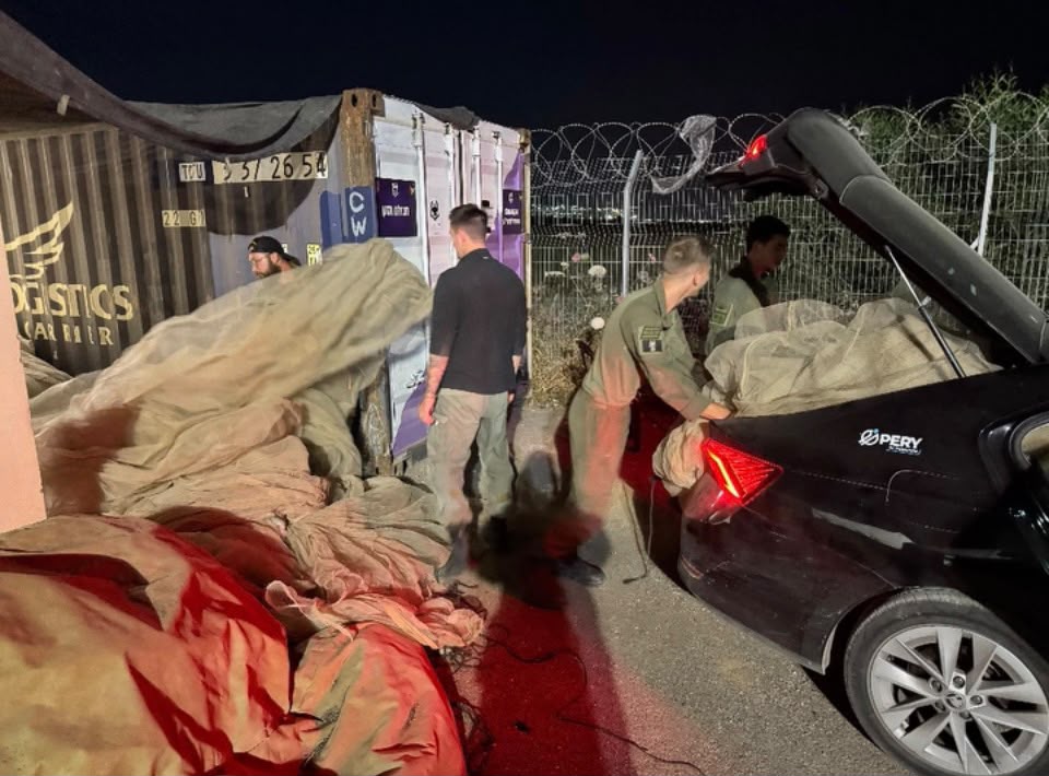 Volunteers with private vehicles delivering netting to a base camp